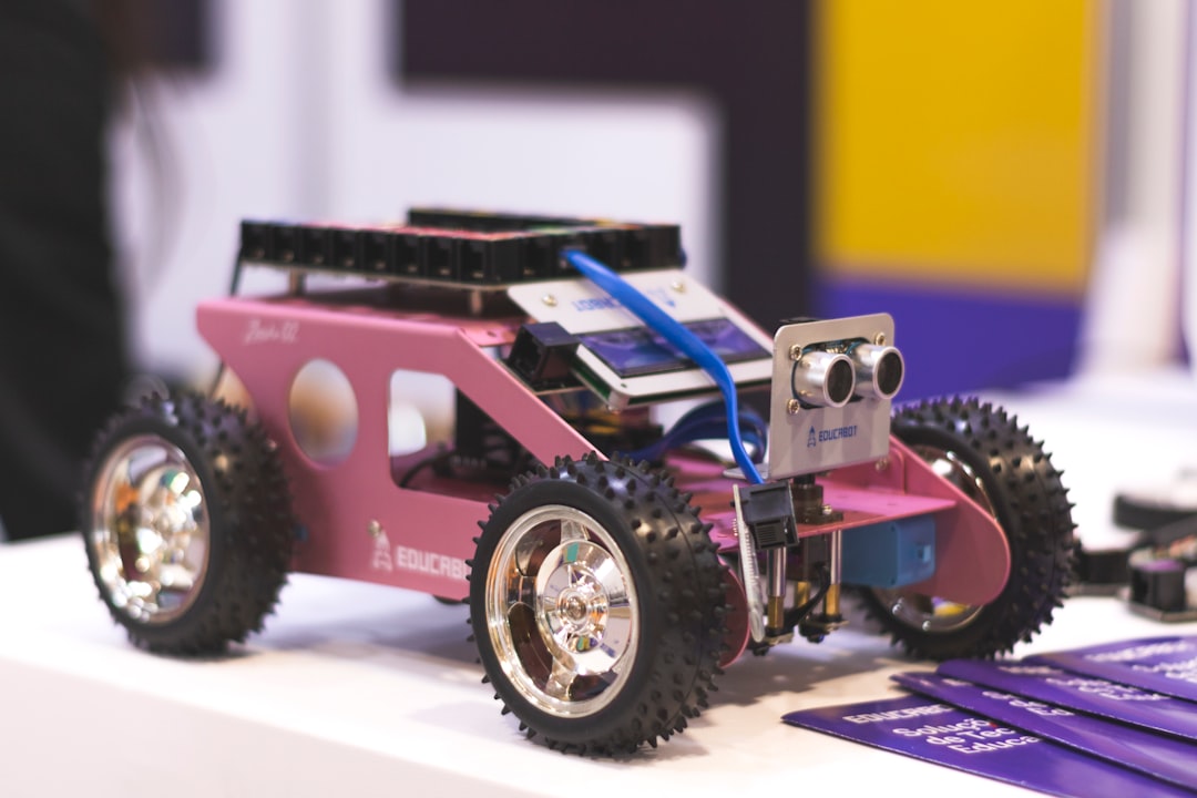 A group of children engaged in building a robotics kit, showcasing teamwork and creativity with various electronic components and tools around them.