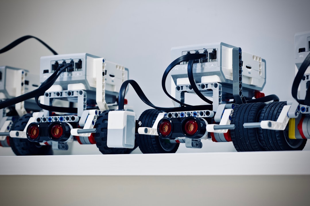 A collection of colorful robotics kits and components laid out on a table, showcasing various sensors, controllers, and assembly parts, ideal for beginners.